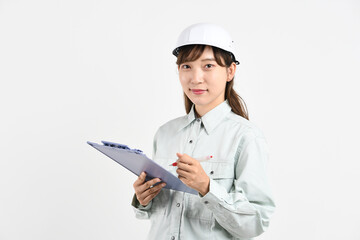 ボードを持つ作業服姿の若いアジア人女性
