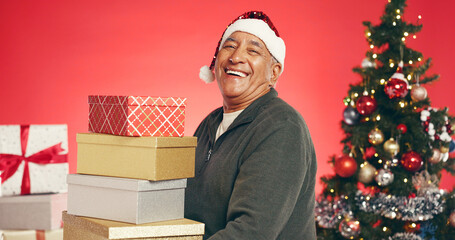 Gift boxes, christmas and senior man in studio for tradition, festive or holiday celebration....