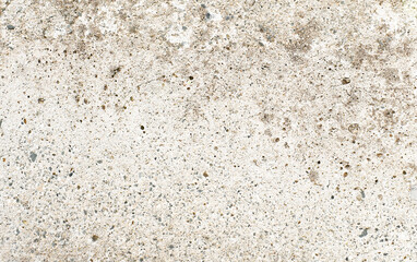 Dirty grunge rough concrete floor with gravel stones texture background. Stains on surface.