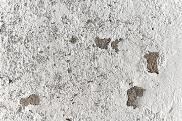 Peeling painted concrete wall. Leaking rain cause the wall and ceiling cracked.
