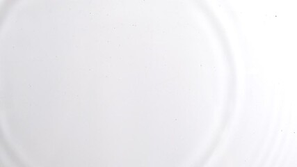 Top view of drop falls into water surface on white background in slow motion. Raindrop falling creating ripple rings texture. Scene of waterdrop fall on a surface of water isolated on white background - Powered by Adobe