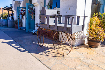 Vintage wooden cart standing in front of the building entrance
