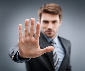 attractive buisnessman making stop gesture