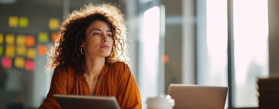 The thoughtful woman in a modern workspace engaging with her ideas. - Powered by Adobe