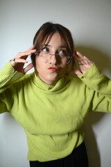 Young woman in glasses. Stylish trendy posing in glasses.    Face emotions.