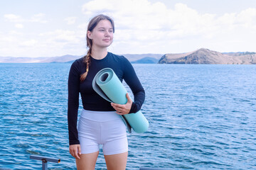 Yoga practice at Lake Baikal embracing fitness and healthy lifestyle by the water