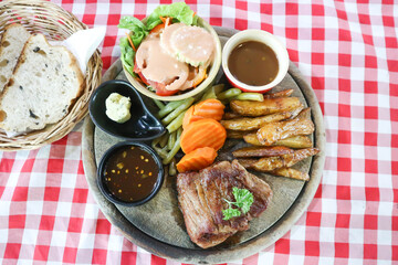 beef steak in gravy sauce or barbecued beef or grilled beef with French fries and vegetable salad