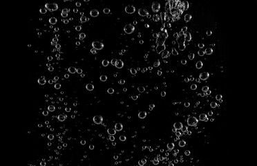 Clear water bubbles rising in dark background, abstract underwater texture ideal for design,...