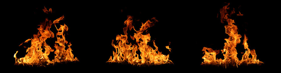 Realistic fire flames isolated on black background, burning effect with glowing orange heat....