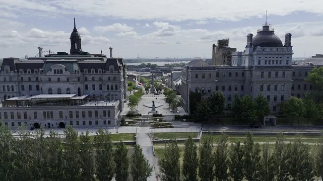 Drone flies east over Le Champ-de-Mars past city hall and Jacques Cartier Place toward the Old Port and the St. Lawrence River in Montreal, Quebec, Canada