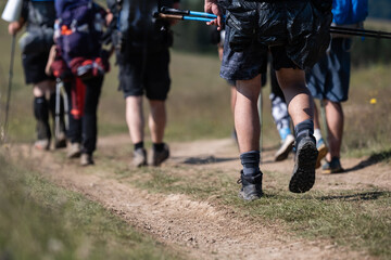 Fototapeta premium Hikers walking on dirt trail in countryside