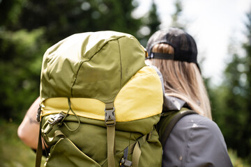 Hiker walking in forest wearing large backpack