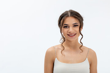 An Elegant Young Woman Smiling Radiantly While Wearing a Light and Beautiful Dress