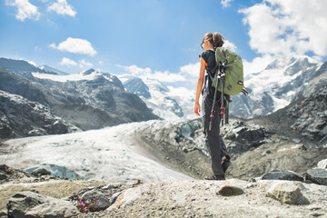 Girl walks in the mountains with glacier view