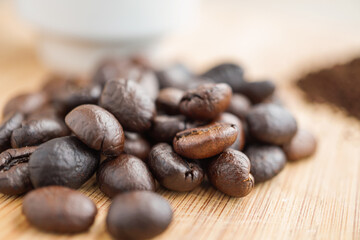 roasted coffee beans with coffee powder and cup