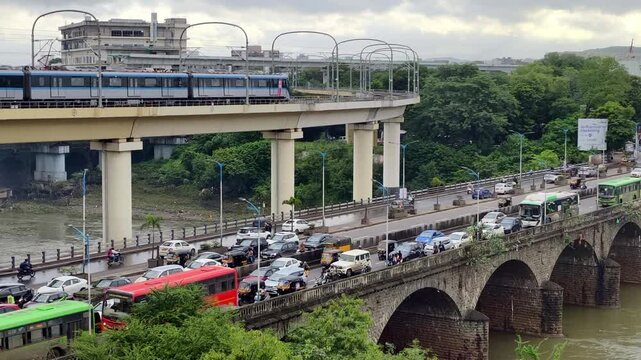 22 August 2025, Pune, Maharashtra, India, Metro runs on an overhead track, Vehicle moves along the Pune metro rail road near Sangam Bridge, now the Indian urban mass transit metro railway system.
