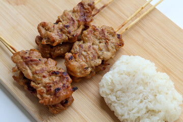 Closeup and High angle view of Grilled pork skewers and sticky rice