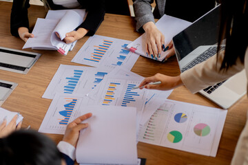 Two professionals in office analyzing documents and contracts, discussing finance strategy, cooperation, and planning agreement for business growth.

