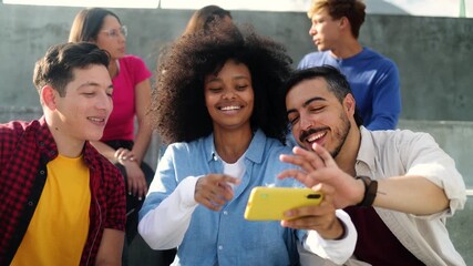 Happy diverse friends using smartphone together at urban city. Youth community life style - Powered by Adobe