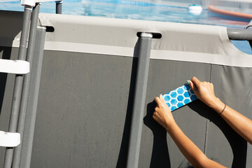 Apply patch on rubber swimming pool fixing or repair