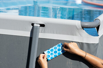Apply patch on rubber swimming pool fixing or repair
