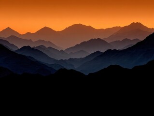 Fototapeta premium Mountains under an orange twilight sky