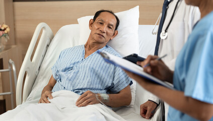 Old Patient with foreground nurse checking at the hospital
