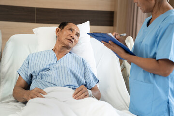 Old Patient with foreground nurse checking at the hospital
