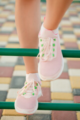 Footsteps on colorful playground equipment highlight playful exercise session at a park in late...