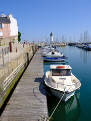 Port of Haliguen and its lighthouse in the background at Quiberon is a commune in the French department of Morbihan, administrative region of Brittany, western France. 