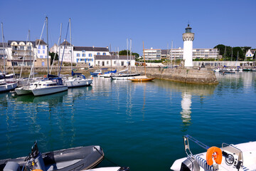 Port of Haliguen and its lighthouse in the background at Quiberon is a commune in the French department of Morbihan, administrative region of Brittany, western France. 