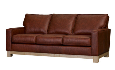 Luxurious brown leather sofa with wooden base studio shot + clipping path. Furniture, interior object.
