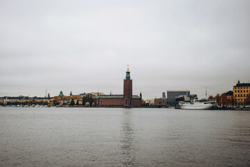 The iconic Stockholm City Hall stands proudly on the waterfront, its towering brick structure...