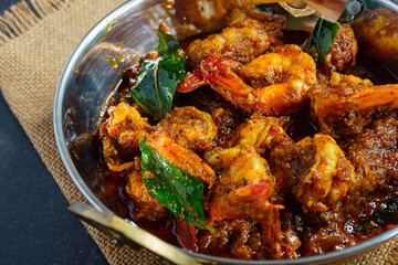 Authentic Kerala style prawn ghee roast, spicy South Indian seafood delicacy made with fresh prawns, clarified butter, roasted spices and curry leaves, traditional Malabar coastal dish