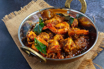 Authentic Kerala style prawn ghee roast, spicy South Indian seafood delicacy made with fresh prawns, clarified butter, roasted spices and curry leaves, traditional Malabar coastal dish