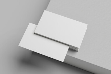White business card stack on a concrete desk 3D rendering