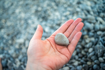 Smooth pebble stones scattered along a coastal shoreline, highlighting natural textures and seaside beauty.