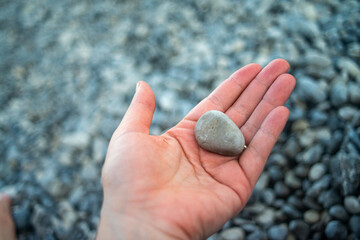 Smooth pebble stones scattered along a coastal shoreline, highlighting natural textures and seaside beauty.