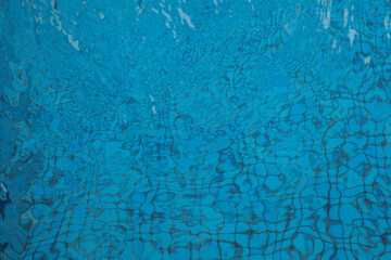 Abstract water ripples in a clear blue swimming pool