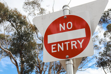 no entry sign with eucalyptus trees in the background