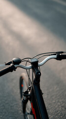 Bicycle handlebars on road with sunlight reflection