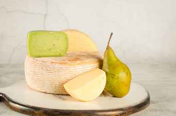 Set of various cheeses on wooden board. Large assortment of craft cheese specialities.