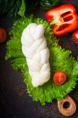 farmhouse homemade mozzarella braid with vegetables on a board