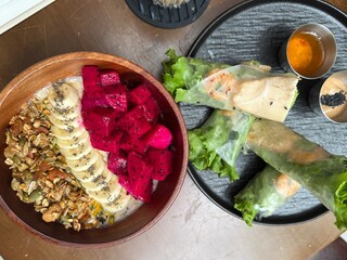 spring rolls and deep plate bowl with fruits Dragon Fruit banana granule 