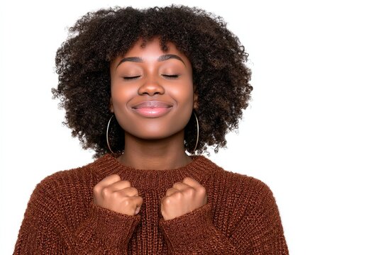 Joyful young woman expressing contentment with closed eyes, captured in cozy autumn sweater with soft lighting, showcasing emotions of tranquility and personal fulfillment