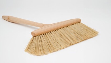 Wooden broom with light bristles on a white background, studio shot and high angle.