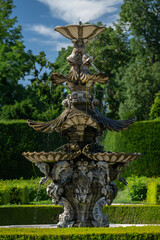 A large and old castle fountain outdoors in the park.
