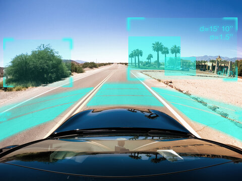 Autonomous self-driving car processing data while driving along a straight road through the desert, USA