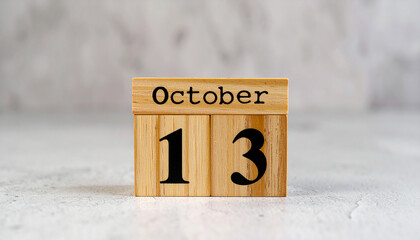 Wooden cubes with text OCTOBER 13. Date, schedule or reminder. Minimalistic calendar design.