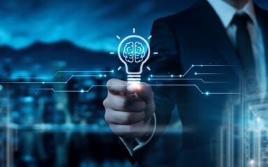 businessman hand drawing light bulb on whiteboard